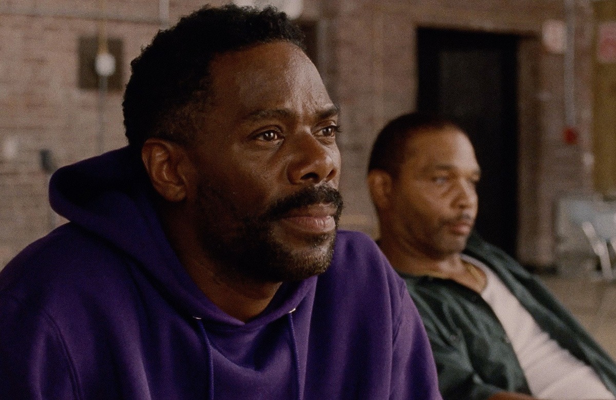 Two men sitting next to each other.